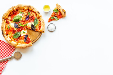 Pizza slices with tomatoes cheese and basil, top view