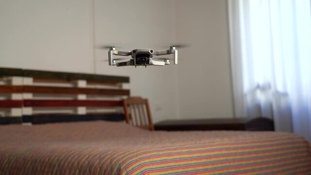A photographer uses a drone for surveying, photography and video of apartment and building interiors - real estate and home staging for sell the home - new 4k aerial technology