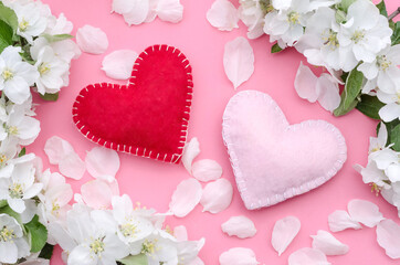 Valentines Day card, two hearts on a pink background with white flowers of an apple tree