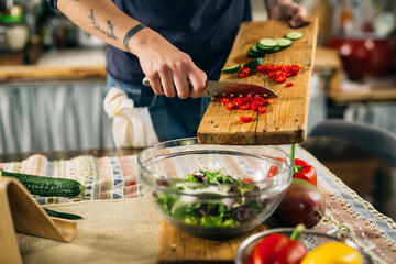 man preparing salad in his kitchen