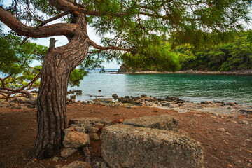 PHASELIS, TURKEY: The scenic view of the beach of Phaselis ancient city on a cloudy day.