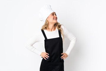 Young Brazilian chef woman isolated on white background posing with arms at hip and smiling