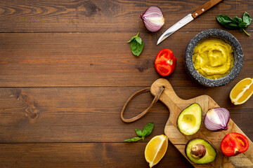 Homemade guacamole avocado dip with tomatoes and lime