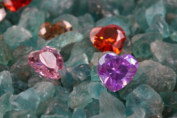 amethyst diamonds in heart shape on raw sky blue gemstones..colorful raw stone background.lived a...