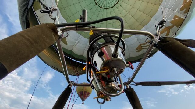 Pilot activating gas burner to uplift the hot air balloon