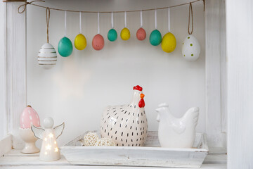 Fragment of the interior. Decorated children's room for Easter. A garland of plastic eggs on the...