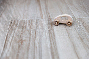 A small car on the floor in the nursery for learning and playing. Copy space