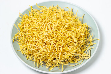 Egg noodles on a white background. Dry homemade noodles on a plate. Traditional pasta