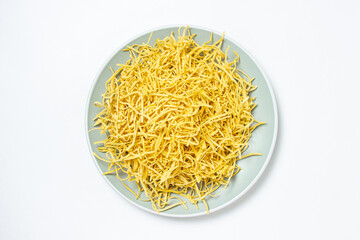 Egg noodles on a white background. Dry homemade noodles on a plate. Traditional pasta