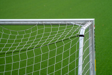 Partial image of green artificial turf in sports stadium