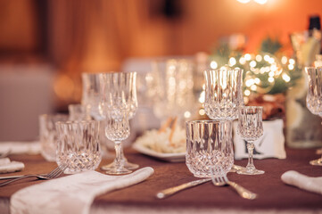 Empty crystal glasses on house dinner table. Restaurant, banquet setting with crystal glasses