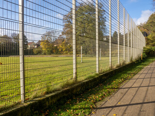 Fence between meadow and path