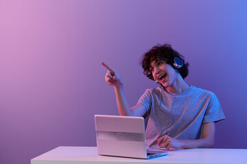 man in headphones in front of laptop entertainment isolated background