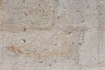 Beautiful horizontal texture of part of old concrete yellow wall with holes