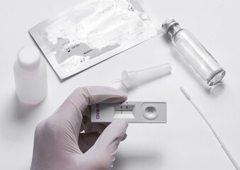 Fototapeta na wymiar Doctor holding a COVID-19 test kit Test results are negative, not infected with coronavirus. with an antigen test kit (ATK)