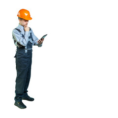 young specialist thought about the project. a man looks at the gadget and plans work. construction engineer. isolated