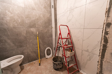 bathroom renovation and tiling. Laying floor ceramic tile