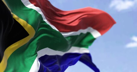 Detailed close up of the national flag of South Africa waving in the wind on a clear day