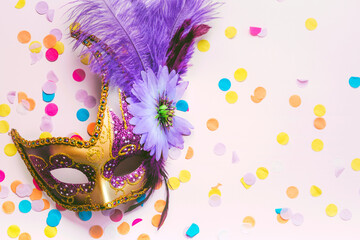Venetian carnival mask and party confetti with copy space. Carnival celebration concept