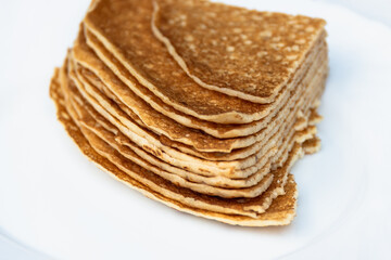 Pancakes on a plate cut into a triangle.
