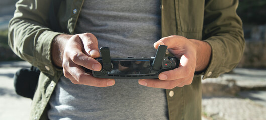 Man holding a remote control of drone.