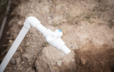 Water plastic tap in yard.