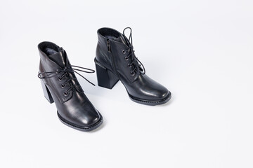 Women's boots with black genuine leather on heels isolated on a white background. photo from the...