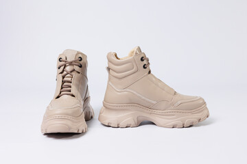 Beautiful shoes on an isolated white studio background. Fashionable beige women's shoe. Elegant stylish footwear.