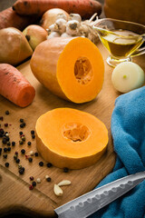 Cooking food from yellow ripe pumpkin on the wooden board. Vegetarian food.