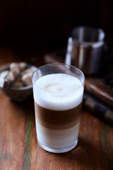 Coffee with milk on wooden background. Soft focus. Close up.