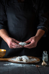 Cooking cutlets by the hands of a chef in the restaurant kitchen. The idea of making a delicious breakfast or lunch