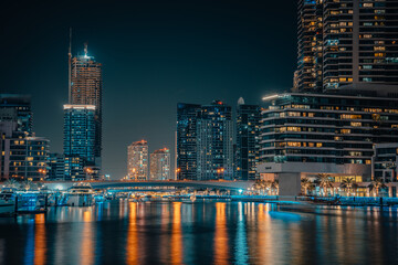 Obraz na płótnie Canvas Fantastic nighttime skyline with illuminated skyscrapers. Dubai, UAE
