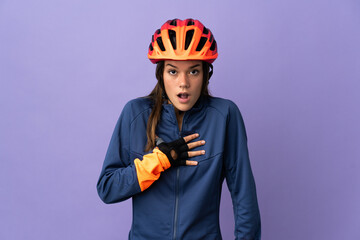 Teenager cyclist girl surprised and shocked while looking right - obrazy, fototapety, plakaty