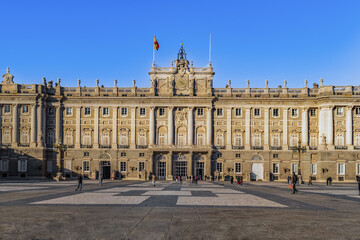 Fototapeta na wymiar Madrid, Spain - November 30, 2021: Front view of the Royal Palace of Madrid. View from the Plaza de la Armeria on the main facade of the Spanish castle