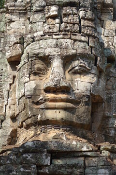 Massive stone relief on top of Victory Gate of impressive Khmer ruin city Angkor Thom (vertical image), Siem Reap, Cambodia