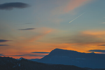 A picturesque landscape view of the French Alps mountains in the Hautes-Alpes department during the sunset