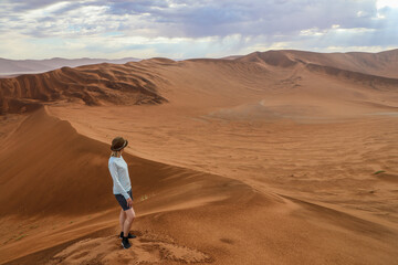 Fototapeta na wymiar Female hiker enjoying view from Big Daddy Dune