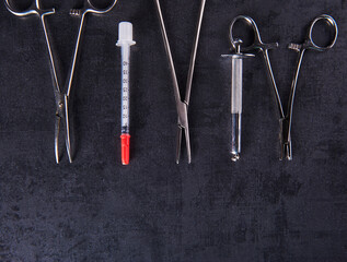 A group of surgical stainless steel body piercing clamps and equipment
