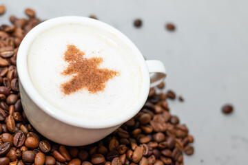 one cup of coffee cappuccino with herringbone on a concrete background with copy space