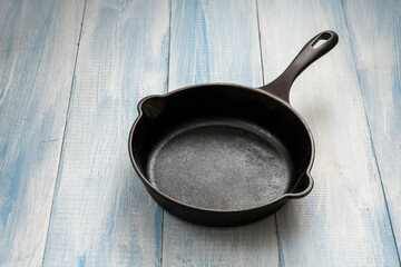 Cast iron skillet on blue and white wooden table