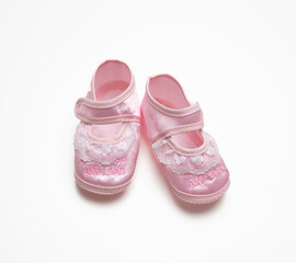 Baby girl shoe isolated on white background, pink cute soft footwear, baby shower