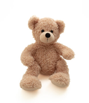 Naklejki Teddy bear sitting isolated on white background. Cute brown stuffed animal