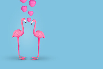 Creative fun concept with a couple of flamingos in love on pastel blue background.