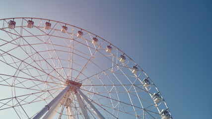 Low angle view of ferris wheel against blue sky