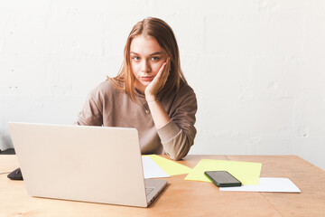 Blond European student girl with a laptop