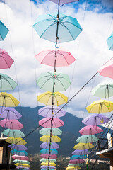 Obraz na płótnie Canvas Colorful umbrella decorations against a cloudy sky. 