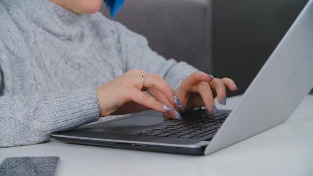 Professional freelancer woman typing on computer. Female working on laptop at home during lockdown. Person doing free lance distant work on notebook pc in closeup stock video filmed in 4k