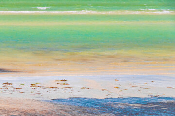 Natural Holbox island beach sandbank green turquoise water waves Mexico.