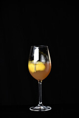 drinks tropical citrus fruits over ice, with sprigs of herbs, grants space for text in blurred background