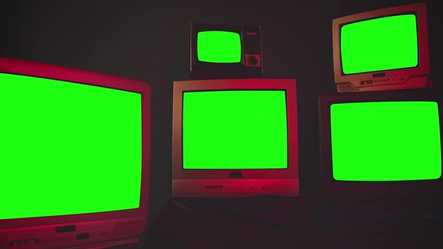 Group of 5 vintage TV with chroma key screens in room with blue black wall